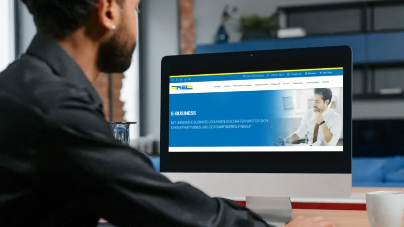 Mann sitzt vor der Software vom C-Teile Management von Piel